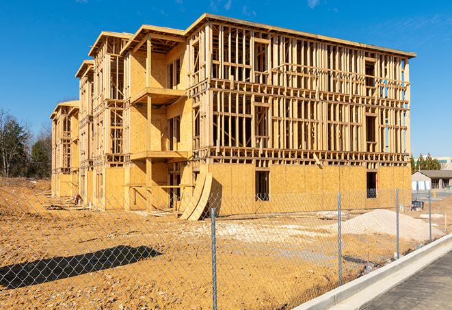 a view of a temporary chain link fence that surrounds a construction site, providing security in Highland CA